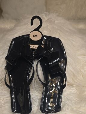 BCBGeneration Black Glossy Slide Sandals with Bow Accent Size 8